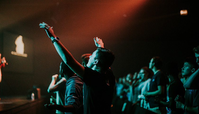 Group of people singing at a worship service