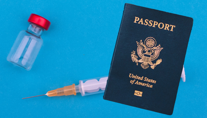 U.S. Passport with vaccine behind