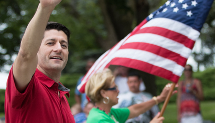 Paul Ryan wearing a red shirt and waving