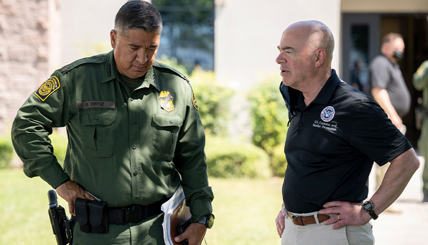 U.S. Dept. of Homeland Security Secretary Alejandro Mayorkas speaks with Chief of the U.S. Border Patrol Raul Ortiz as he tours the Del Rio Port of Entry in Del Rio, Texas, September 20, 2021.