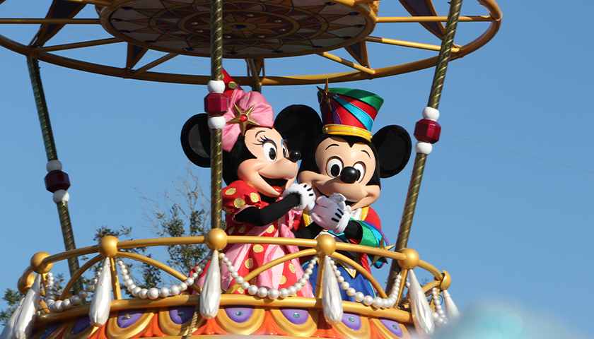 Mickey and Minnie Mouse riding on a float in Magic Kingdom